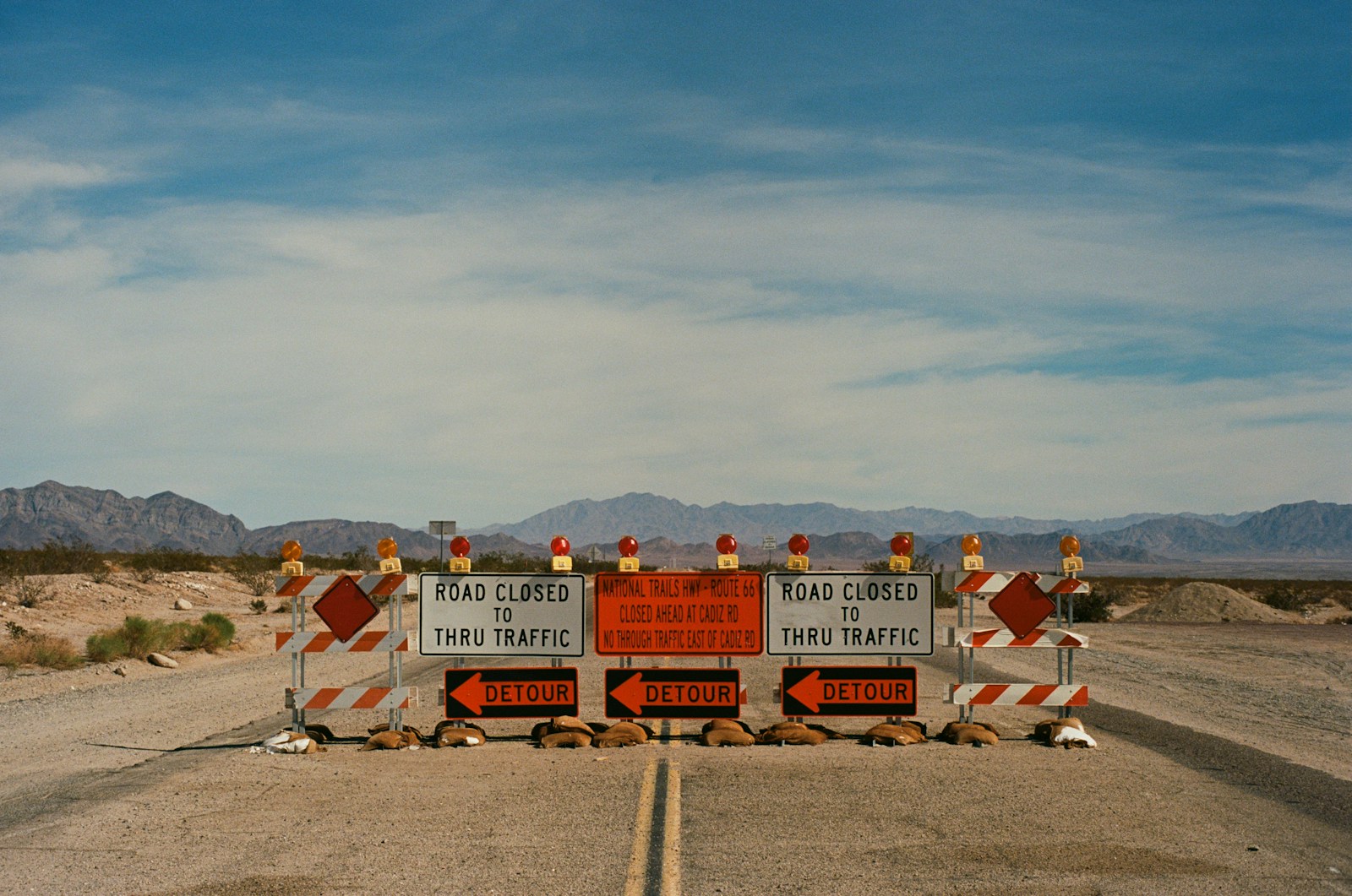 a couple of road signs sitting on the side of a road